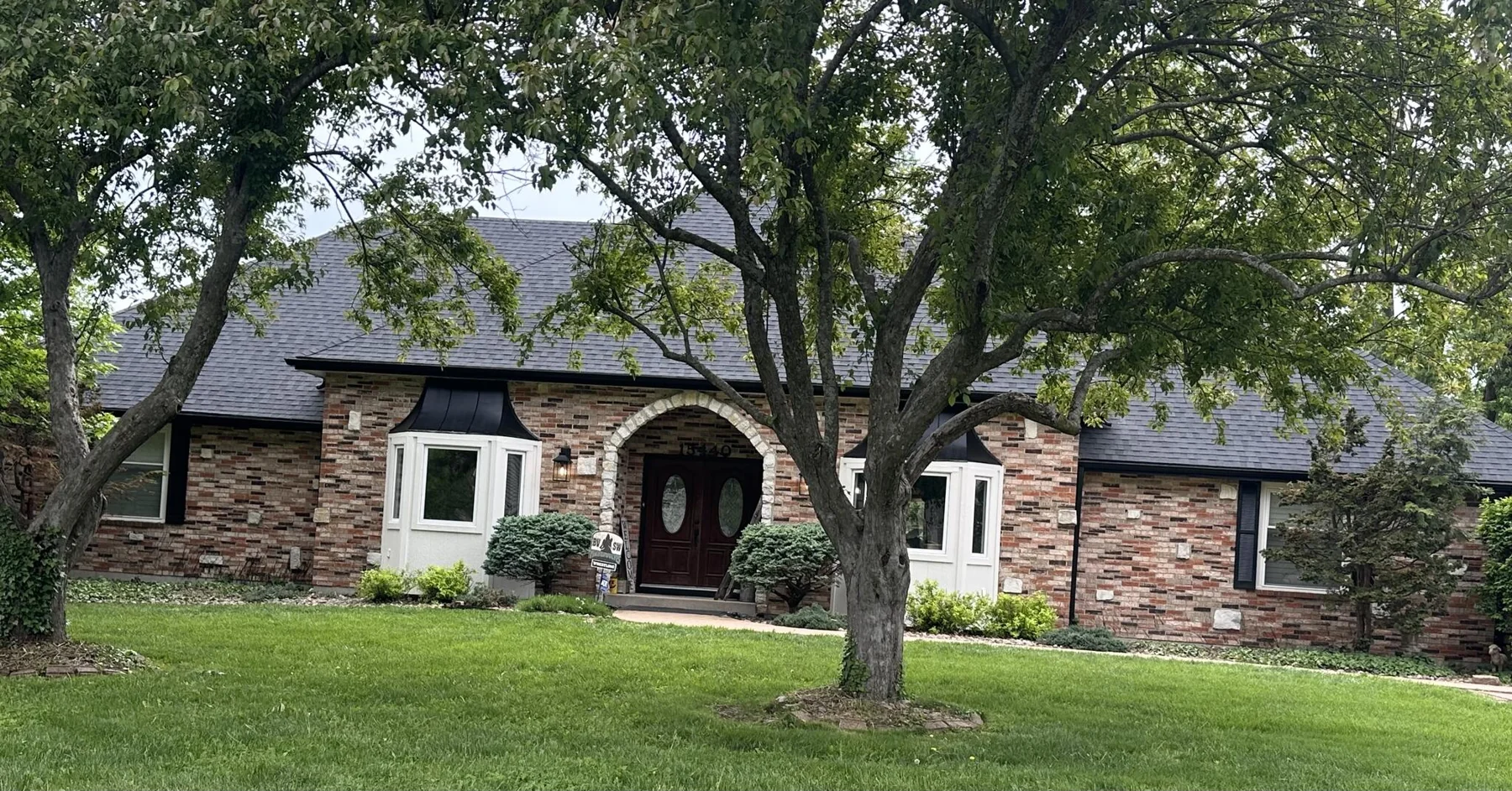 Brick home with cream siding and white trim