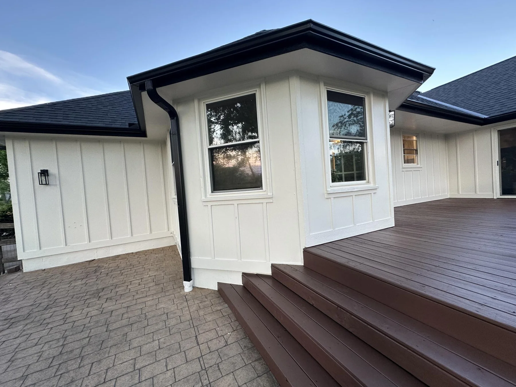 Cream siding, white railing, and wood deck details